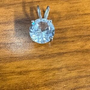 Sterling Silver 925 (92.5% pure Silver) with a White Sapphire gemstone center